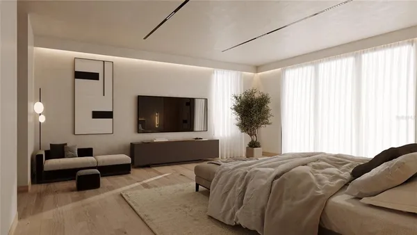 a bedroom with a large bed and a flat screen tv