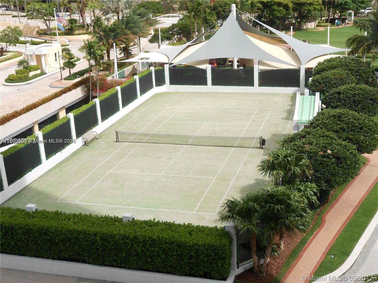 900 Brickell Key Boulevard, Unit 2602 Miami, FL 33131 - Photo 11 of 29 a front view of a house with a yard