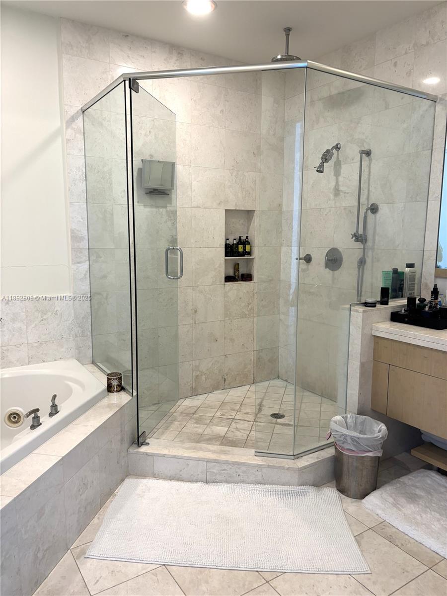 900 Brickell Key Boulevard, Unit 2602 Miami, FL 33131 - Photo 19 of 29 a bathroom with a bathtub and a shower