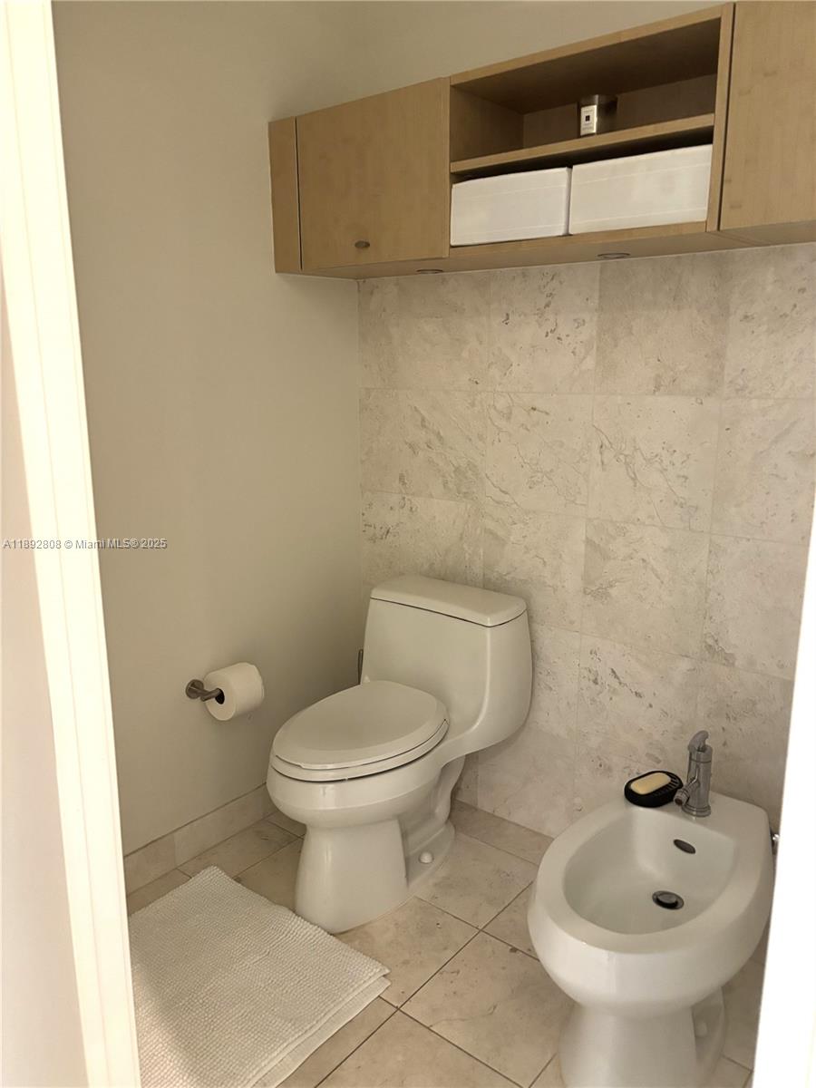 900 Brickell Key Boulevard, Unit 2602 Miami, FL 33131 - Photo 20 of 29 a white toilet sitting next to a bathroom sink