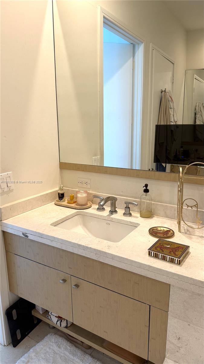 900 Brickell Key Boulevard, Unit 2602 Miami, FL 33131 - Photo 21 of 29 a bathroom with a sink and a mirror