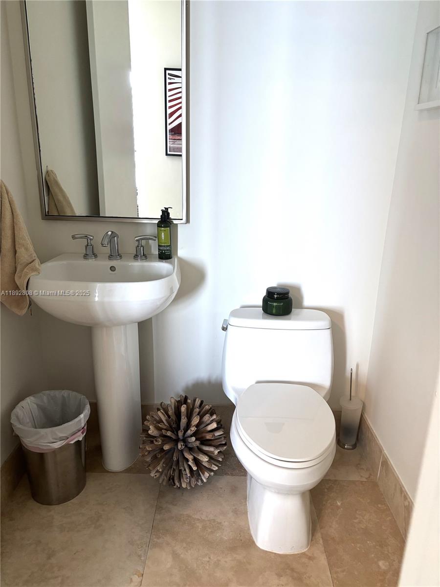 900 Brickell Key Boulevard, Unit 2602 Miami, FL 33131 - Photo 22 of 29 a bathroom with a toilet sink and mirror