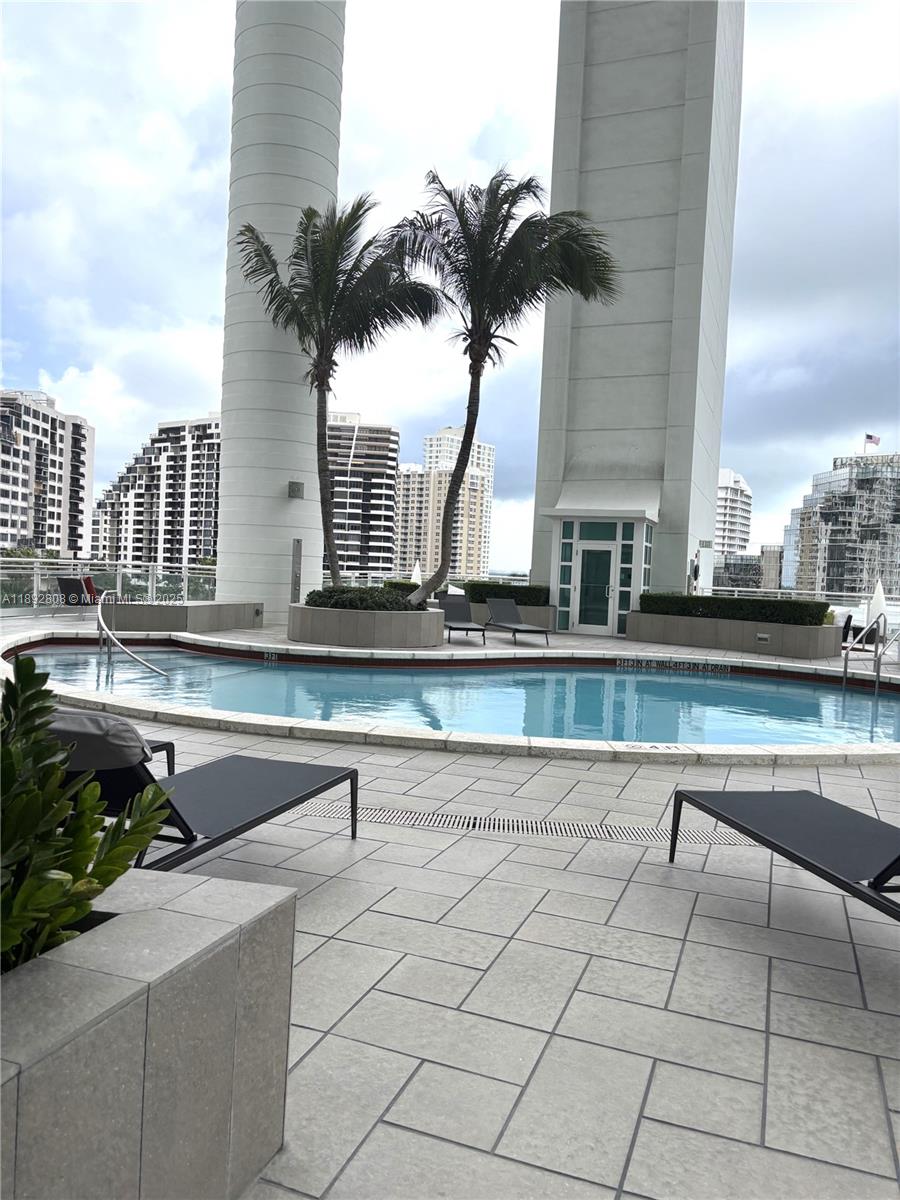 900 Brickell Key Boulevard, Unit 2602 Miami, FL 33131 - Photo 26 of 29 a picture of a table and chairs in patio