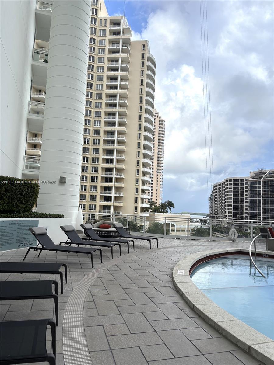 900 Brickell Key Boulevard, Unit 2602 Miami, FL 33131 - Photo 28 of 29 a roof deck with couches and potted plants