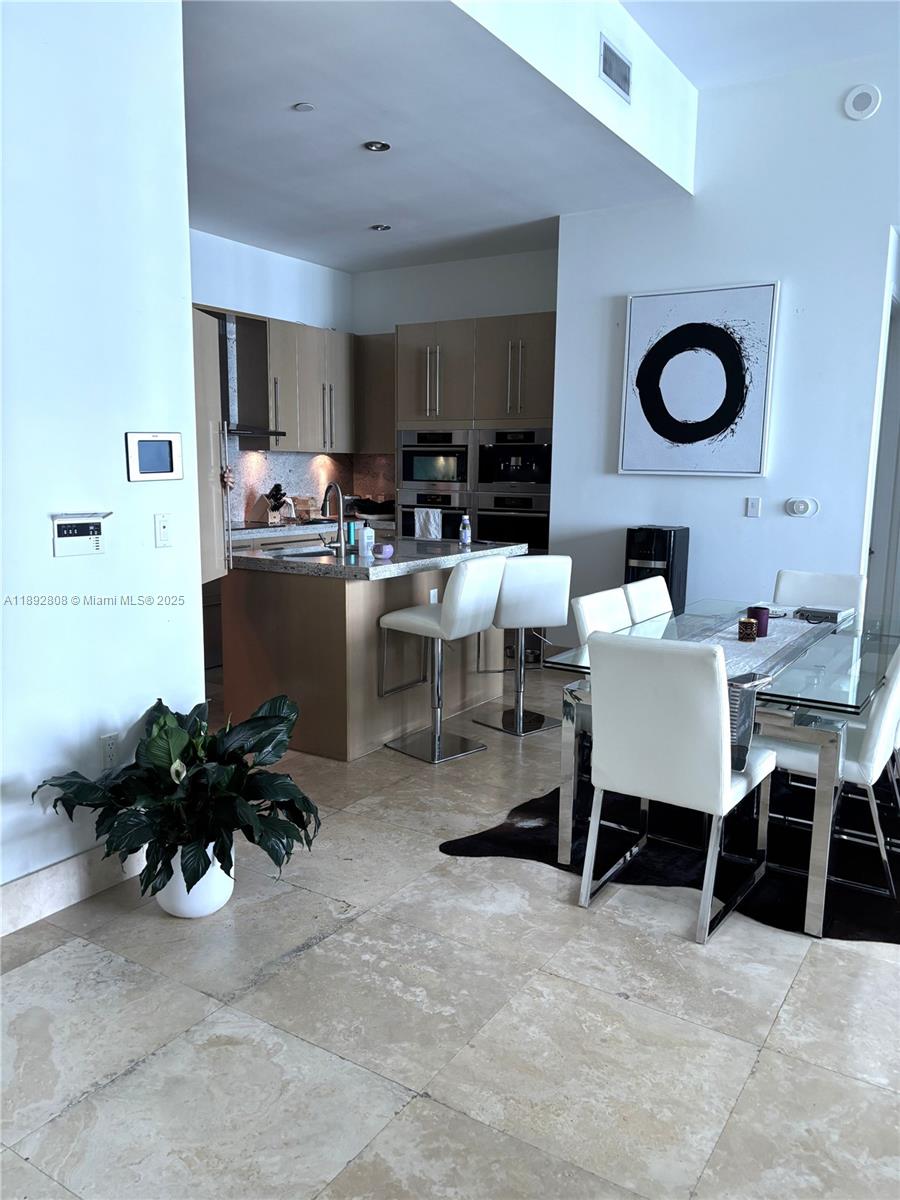 900 Brickell Key Boulevard, Unit 2602 Miami, FL 33131 - Photo 4 of 29 a living room with furniture and a large window