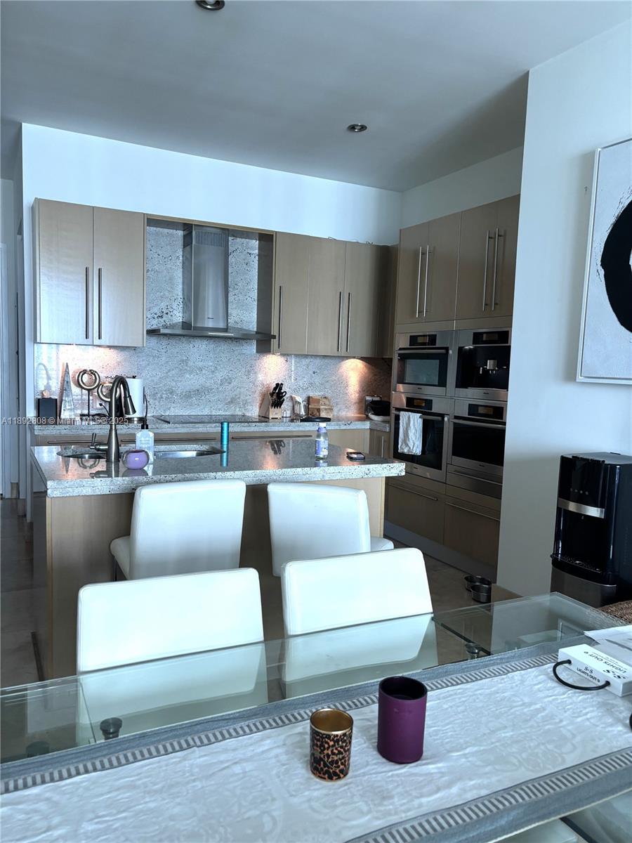 900 Brickell Key Boulevard, Unit 2602 Miami, FL 33131 - Photo 6 of 29 a living room with furniture and a fireplace