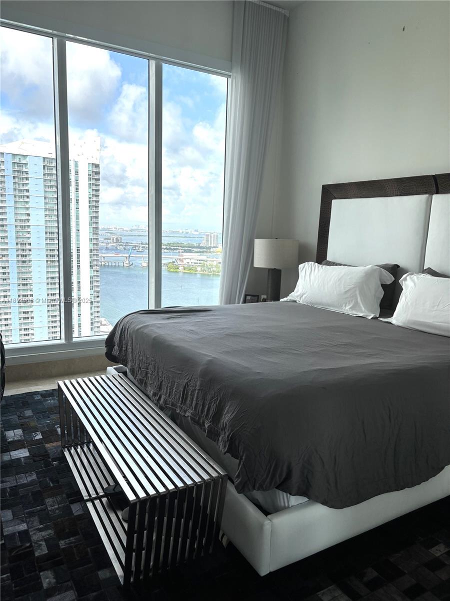 900 Brickell Key Boulevard, Unit 2602 Miami, FL 33131 - Photo 7 of 29 a bedroom with a large bed and a large window