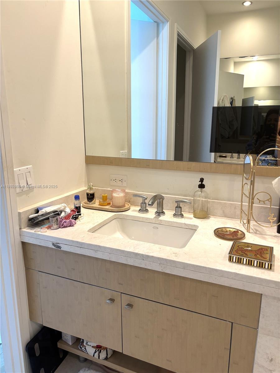 900 Brickell Key Boulevard, Unit 2602 Miami, FL 33131 - Photo 8 of 29 a bathroom with a sink and a mirror
