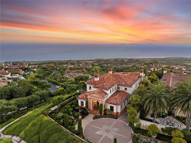 an aerial view of residential houses with outdoor space and trees
