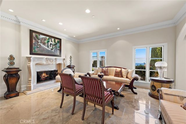 a view of a dining room with furniture a chandelier and wooden floor