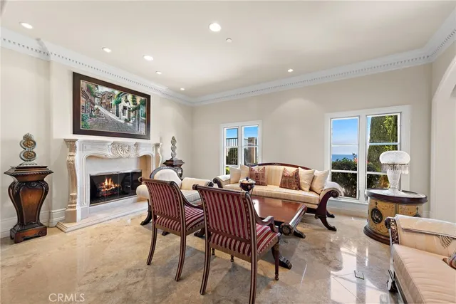 a view of a dining room with furniture a chandelier and wooden floor
