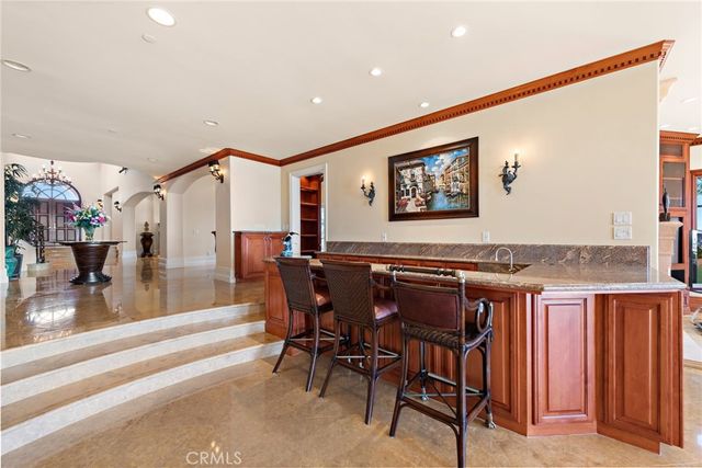 a living room with furniture kitchen view and a fireplace