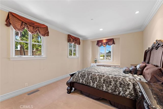 a large bedroom with a large bed and a large window