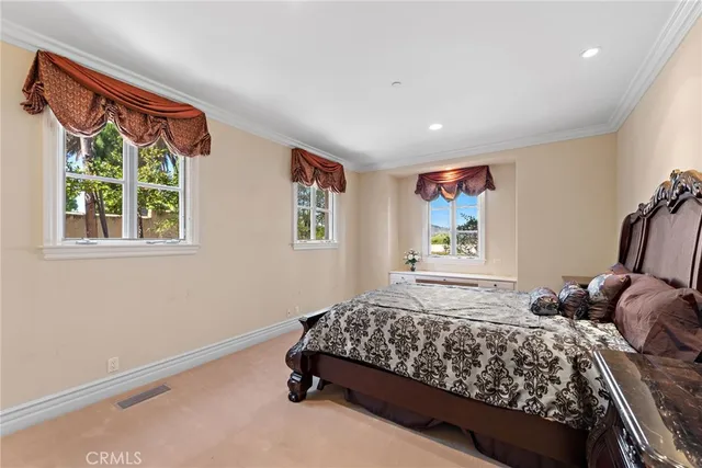a large bedroom with a large bed and a large window