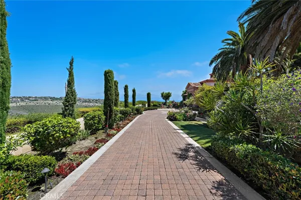 a view of a garden with tall buildings