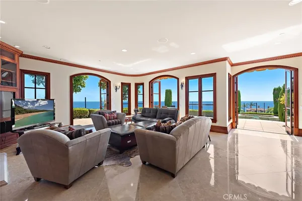 a view of a dining room with furniture wooden floor chandelier and a chandelier