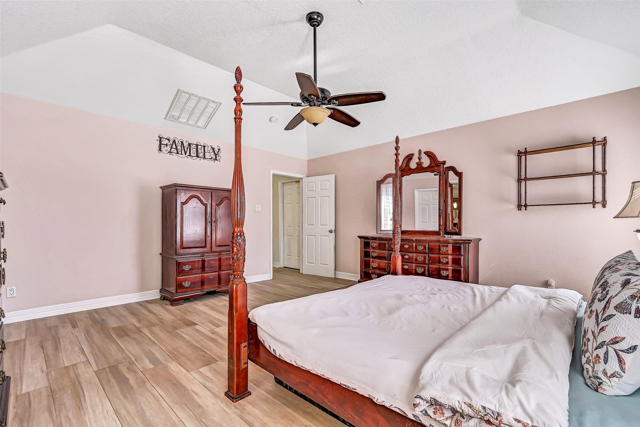 4721 Willow Street Pasadena, TX 77586 - Photo 15 of 30 a bedroom with a bed and a chandelier