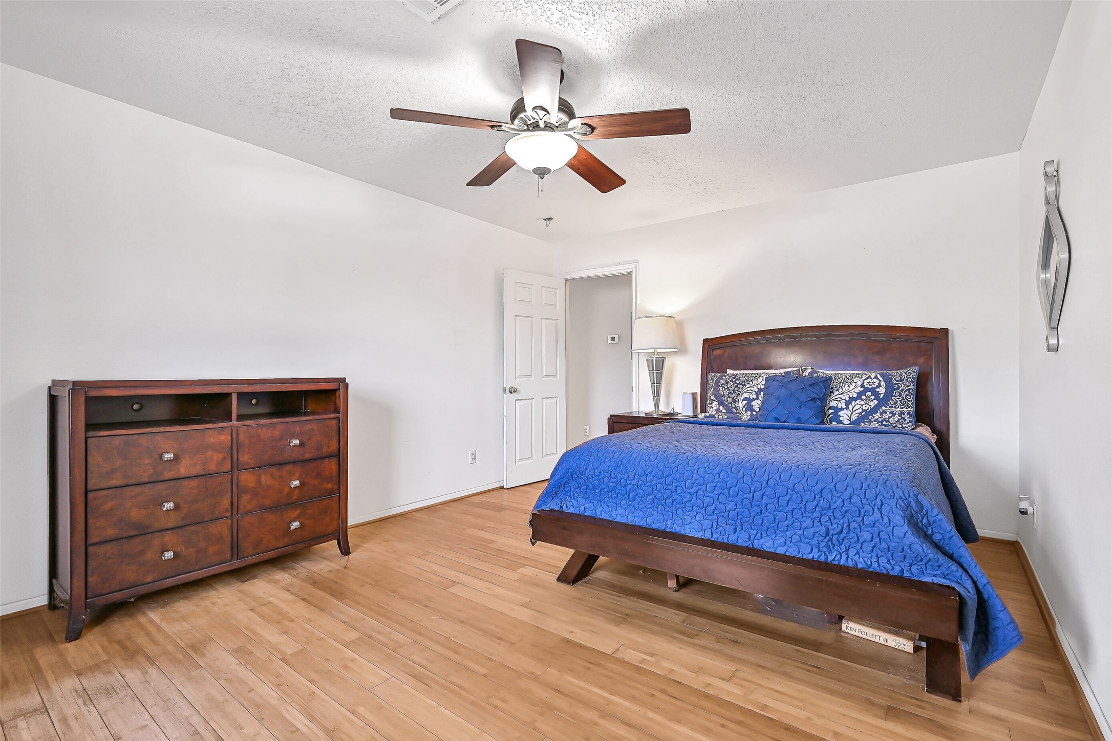 4721 Willow Street Pasadena, TX 77586 - Photo 19 of 30 a bedroom with a bed and a dresser