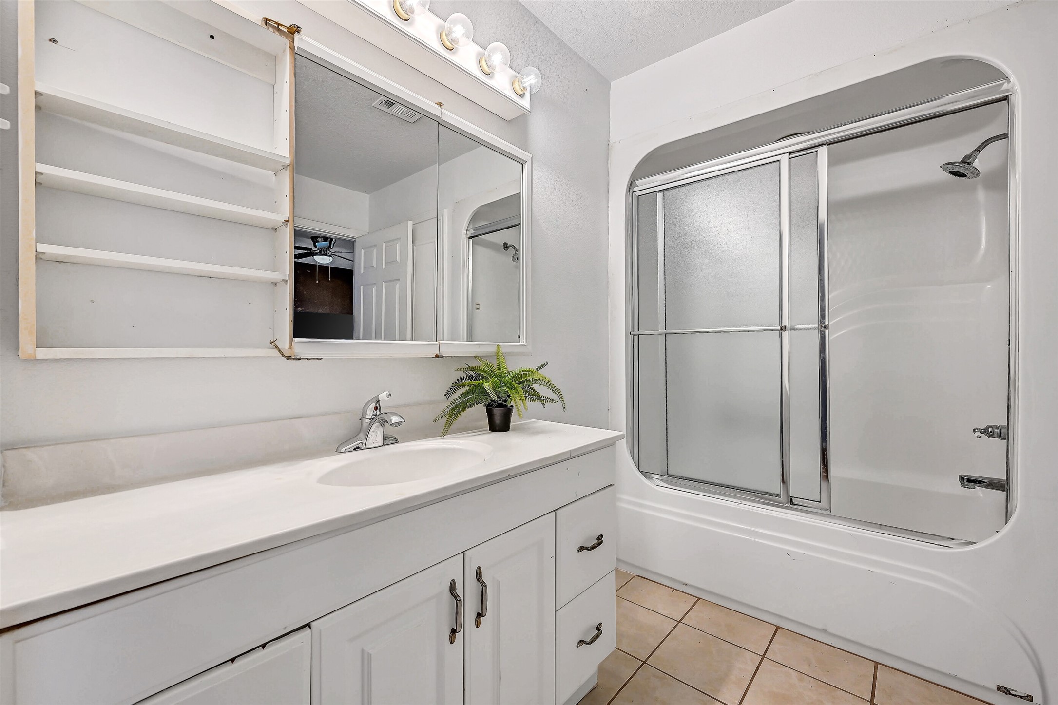 4721 Willow Street Pasadena, TX 77586 - Photo 21 of 30 a bathroom with a shower sink and mirror