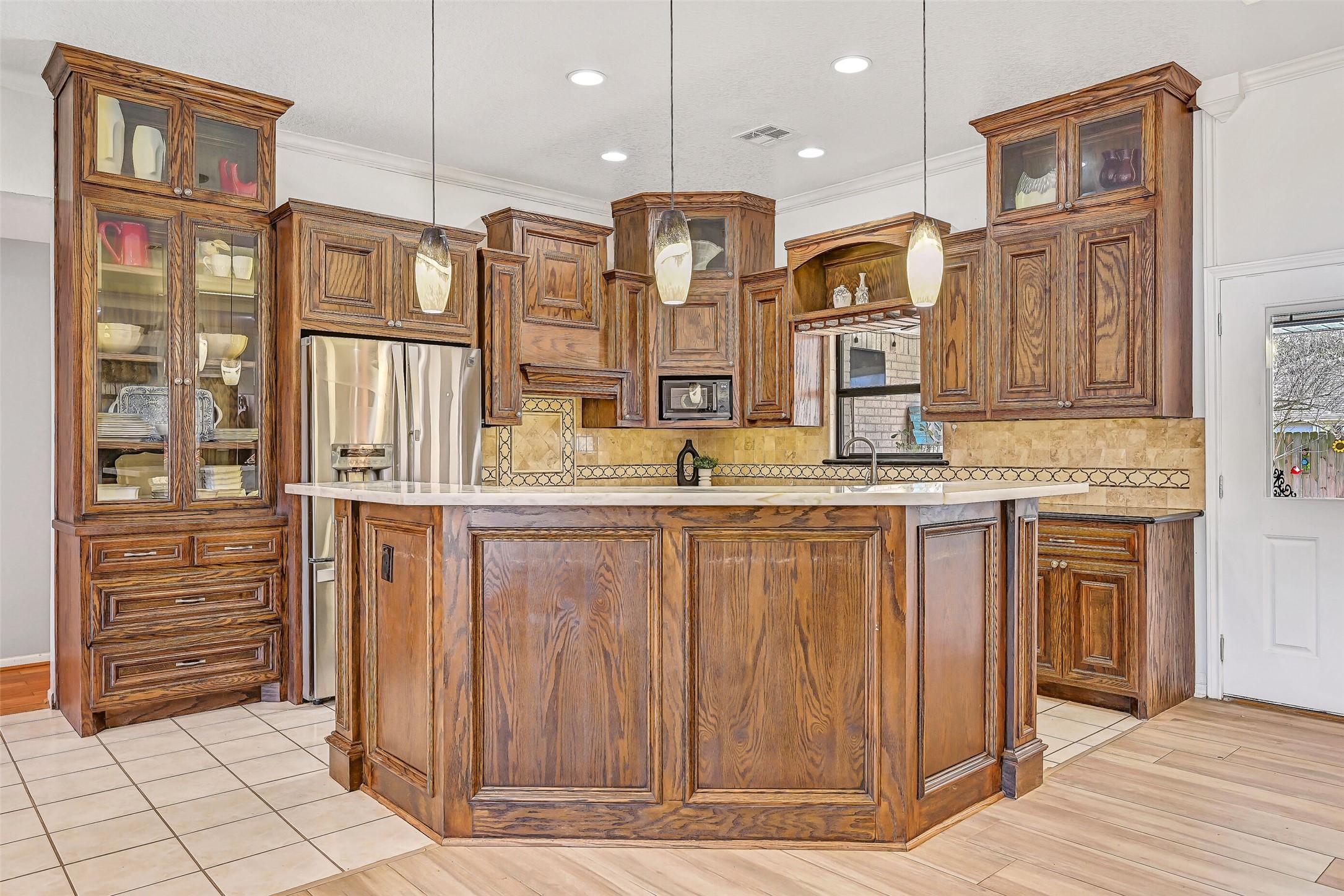 4721 Willow Street Pasadena, TX 77586 - Photo 7 of 31 a kitchen with cabinets and outdoor space