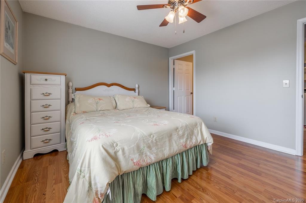 5523 Hornaday Road, Unit G Greensboro, NC 27409 - Photo 15 of 20 a bedroom with a bed and a chandelier