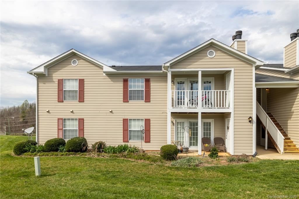 5523 Hornaday Road, Unit G Greensboro, NC 27409 - Photo 3 of 20 a front view of a house with a yard