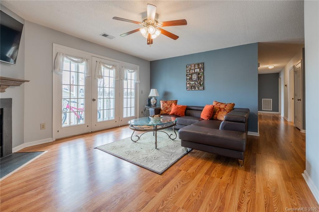 5523 Hornaday Road, Unit G Greensboro, NC 27409 - Photo 4 of 20 a living room with furniture and a wooden floor