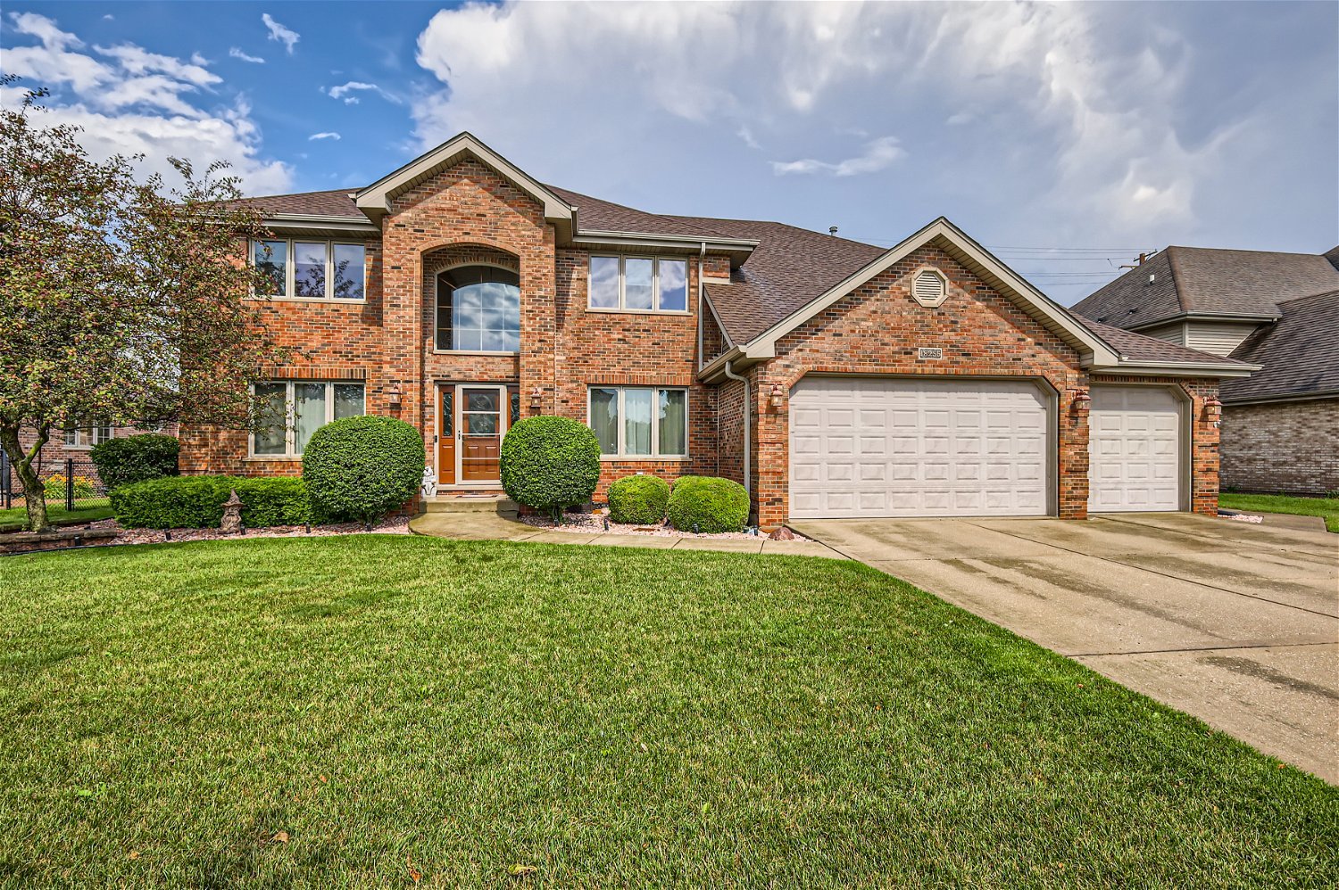 18255 Cork Road Tinley Park, IL 60477 - Photo 1 of 29 a front view of a house with a garden