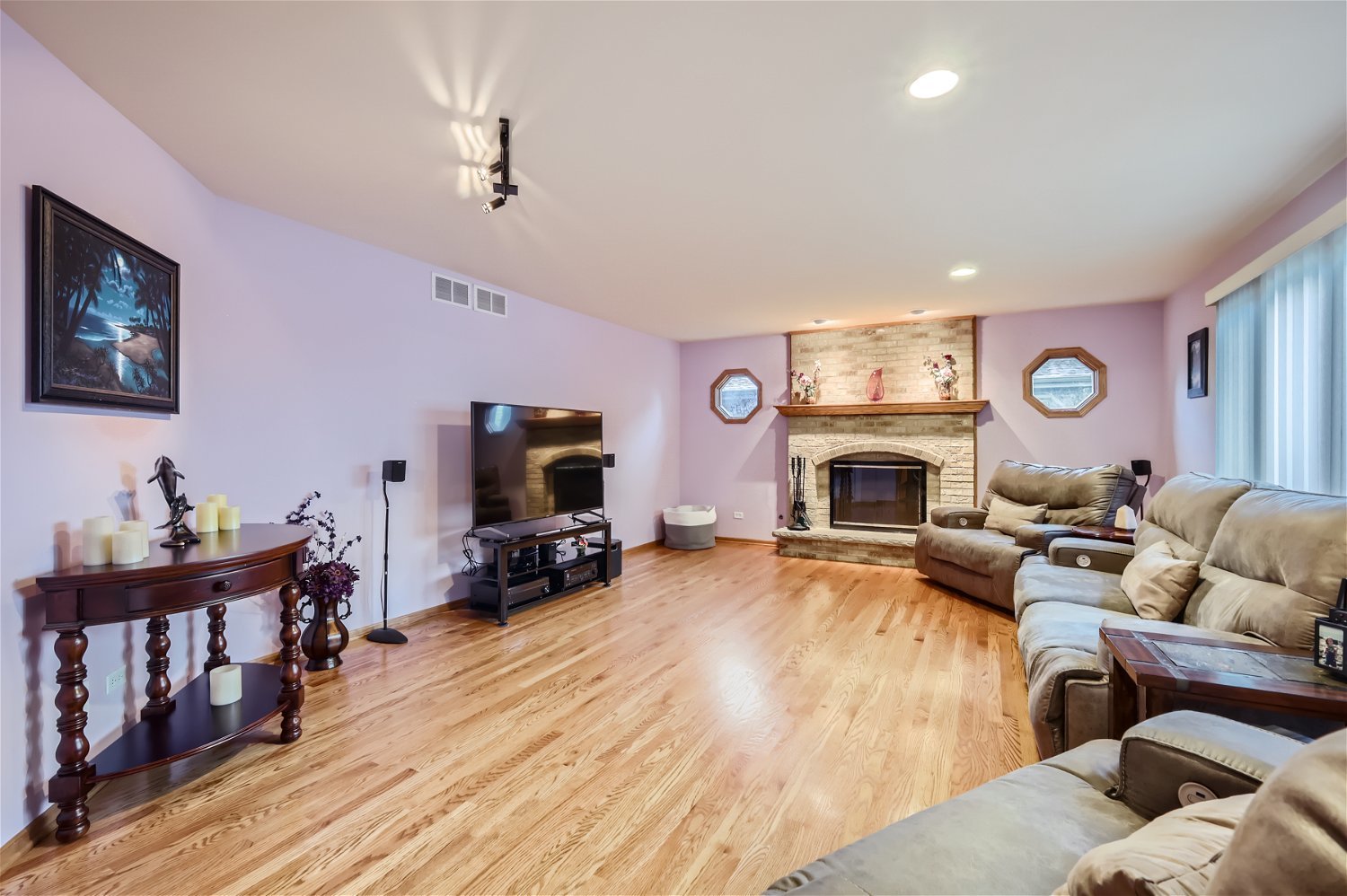 18255 Cork Road Tinley Park, IL 60477 - Photo 12 of 29 a living room with furniture a fireplace and a flat screen tv