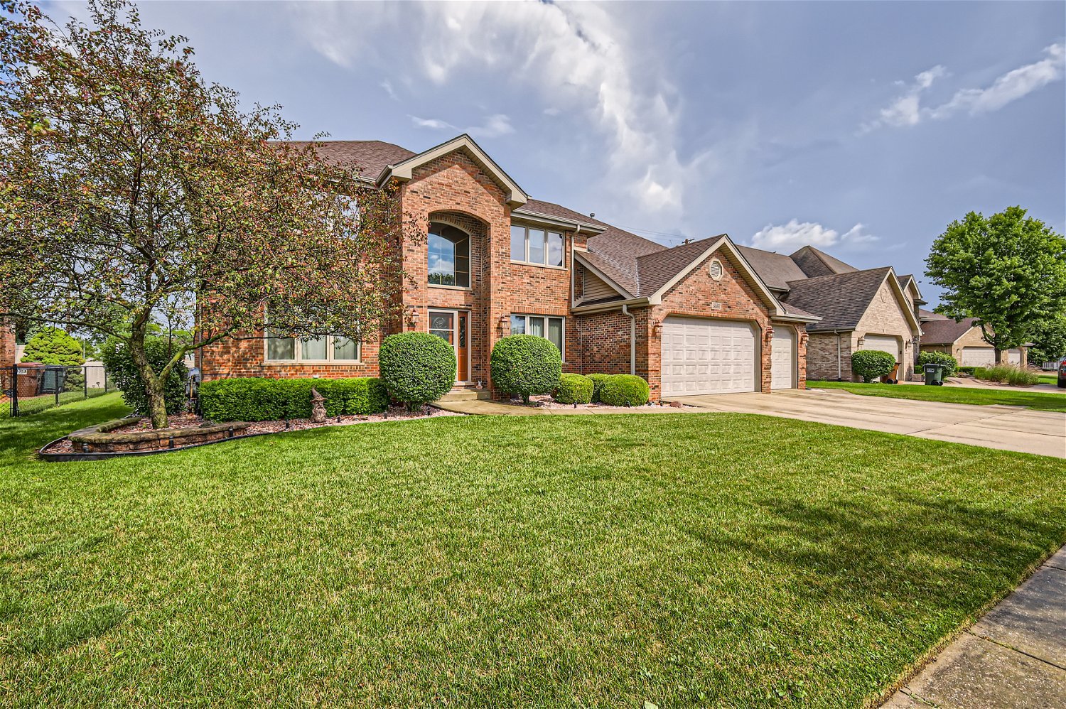 18255 Cork Road Tinley Park, IL 60477 - Photo 2 of 29 a front view of a house with garden