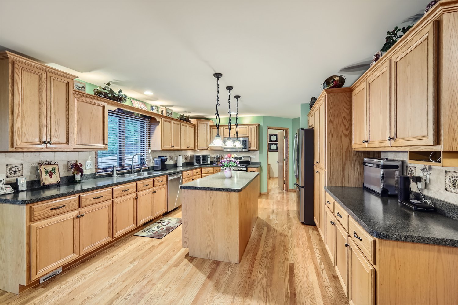 18255 Cork Road Tinley Park, IL 60477 - Photo 6 of 29 a kitchen with stainless steel appliances granite countertop a sink a stove and refrigerator