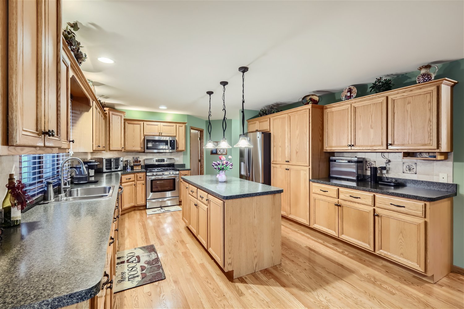 18255 Cork Road Tinley Park, IL 60477 - Photo 7 of 29 a kitchen with stainless steel appliances granite countertop a stove top oven a sink dishwasher and white cabinets with wooden floor