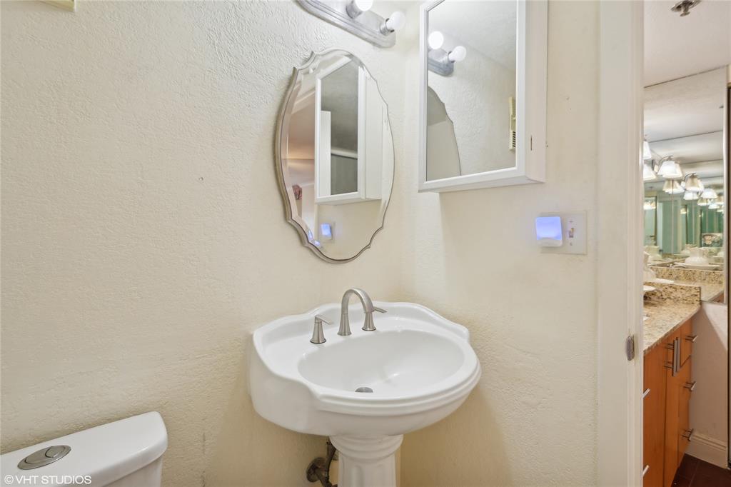 3940 Inverrary Boulevard, Unit 403A Lauderhill, FL 33319 - Photo 17 of 34 a bathroom with a sink a mirror and a toilet
