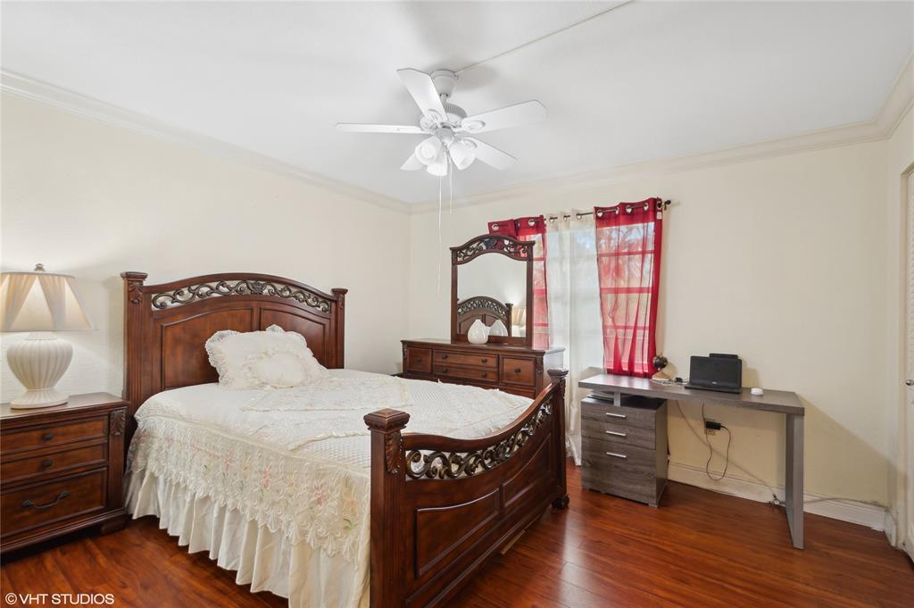 3940 Inverrary Boulevard, Unit 403A Lauderhill, FL 33319 - Photo 18 of 34 a bedroom with a bed and a chandelier