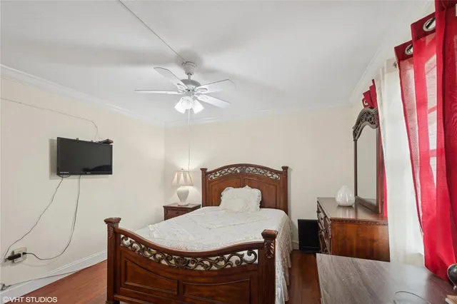 a bedroom with a bed window and a flat screen tv