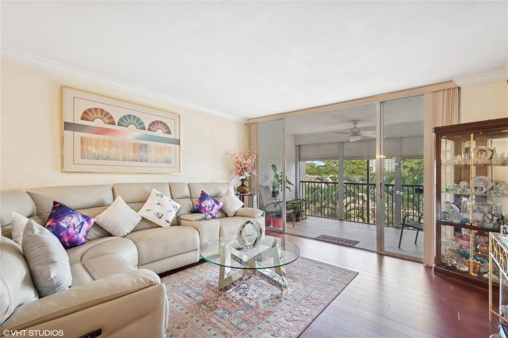 3940 Inverrary Boulevard, Unit 403A Lauderhill, FL 33319 - Photo 2 of 34 a living room with furniture and a floor to ceiling window