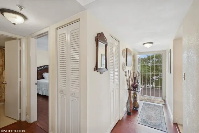 a view of a hallway with wooden floor and entryway