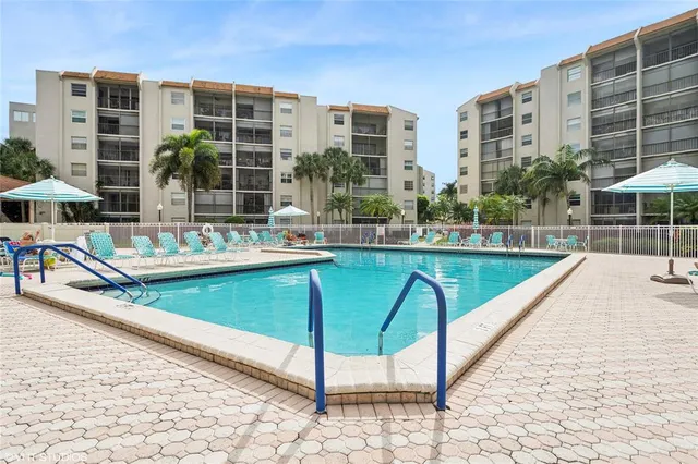 a swimming pool with outdoor seating and yard