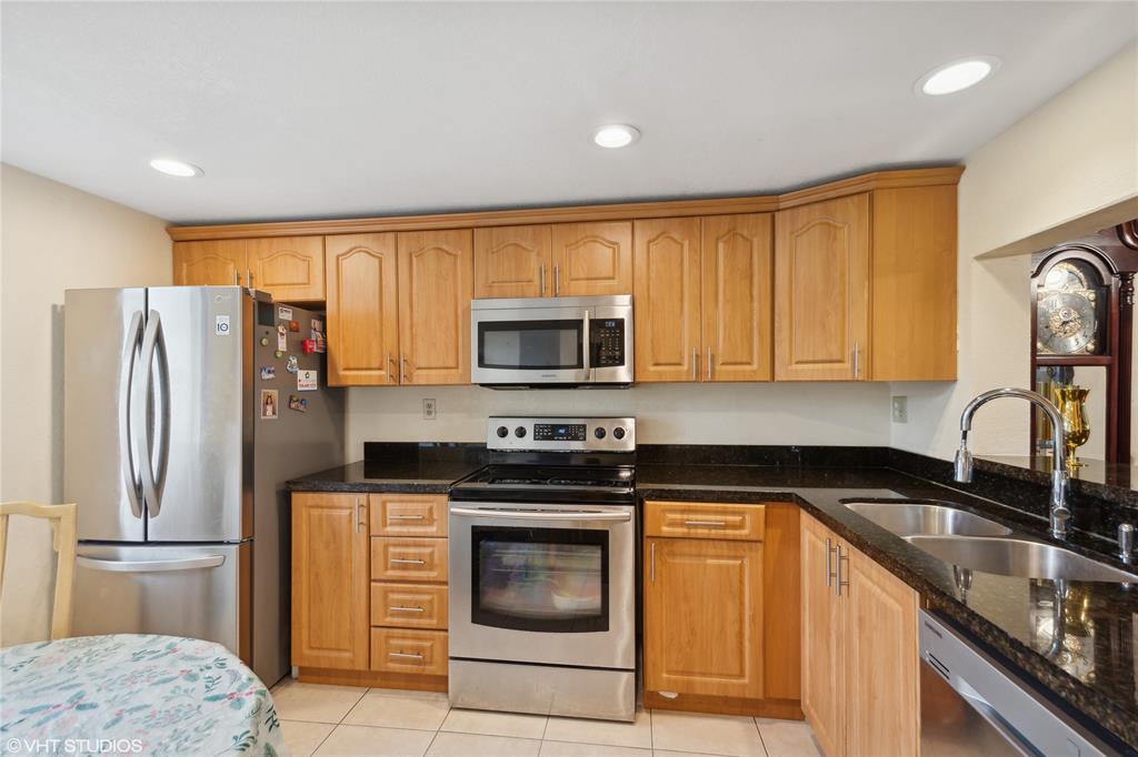 3940 Inverrary Boulevard, Unit 403A Lauderhill, FL 33319 - Photo 5 of 34 a kitchen with a refrigerator sink and microwave