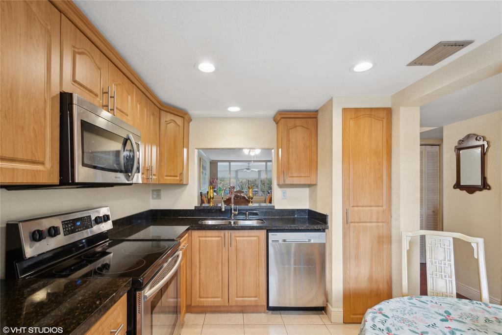 3940 Inverrary Boulevard, Unit 403A Lauderhill, FL 33319 - Photo 6 of 34 a kitchen with a stove a sink and a refrigerator