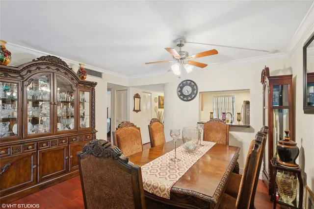 a view of a dining room with furniture and chandelier