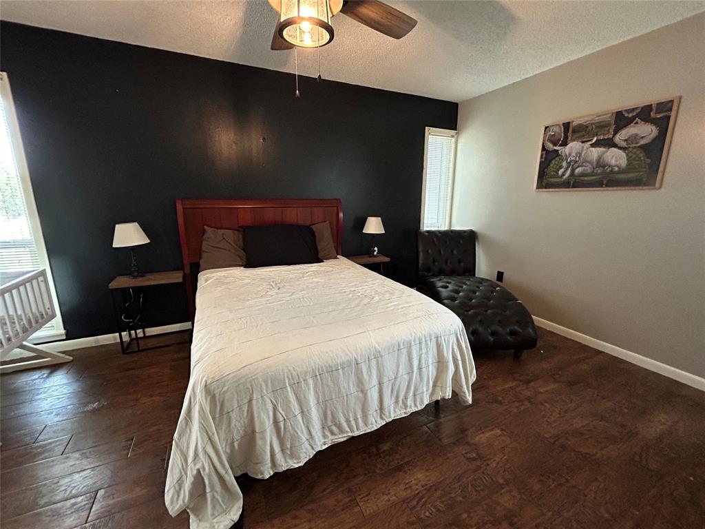 13 Rim Rock Road Goldthwaite, TX 76844 - Photo 18 of 30 a bedroom with a bed and wooden floor