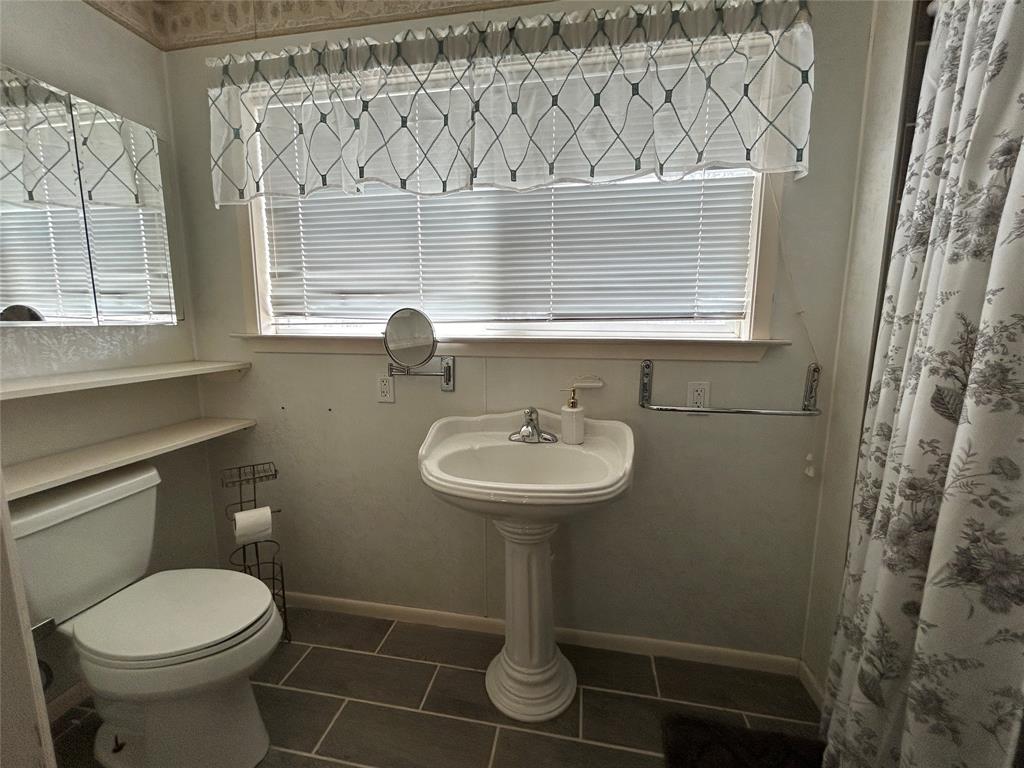 13 Rim Rock Road Goldthwaite, TX 76844 - Photo 19 of 30 a bathroom with a sink toilet and a mirror