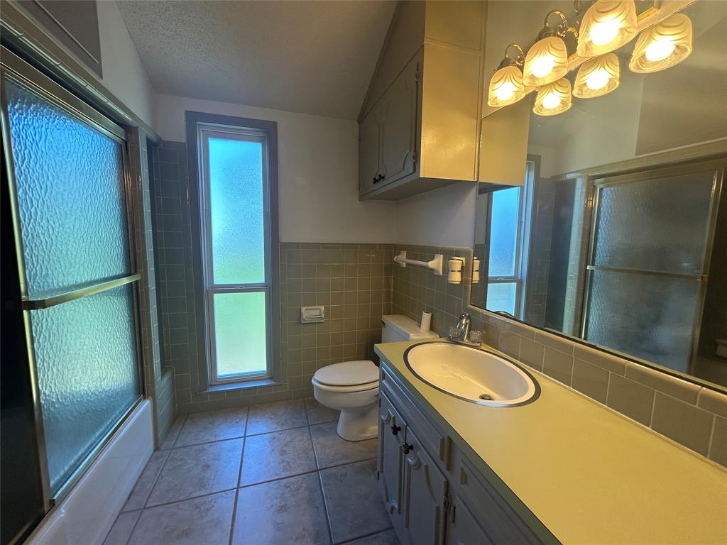 13 Rim Rock Road Goldthwaite, TX 76844 - Photo 23 of 30 a bathroom with a sink a toilet and shower