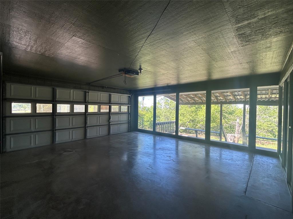 13 Rim Rock Road Goldthwaite, TX 76844 - Photo 28 of 30 an empty room with wooden floor and windows