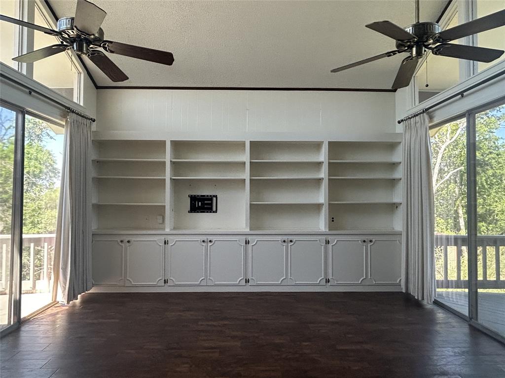13 Rim Rock Road Goldthwaite, TX 76844 - Photo 3 of 30 a view of an empty room with a window and wooden floor