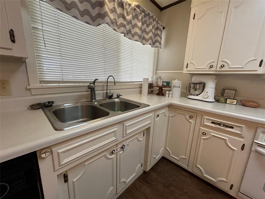 13 Rim Rock Road Goldthwaite, TX 76844 - Photo 8 of 30 a kitchen with white cabinets and white appliances