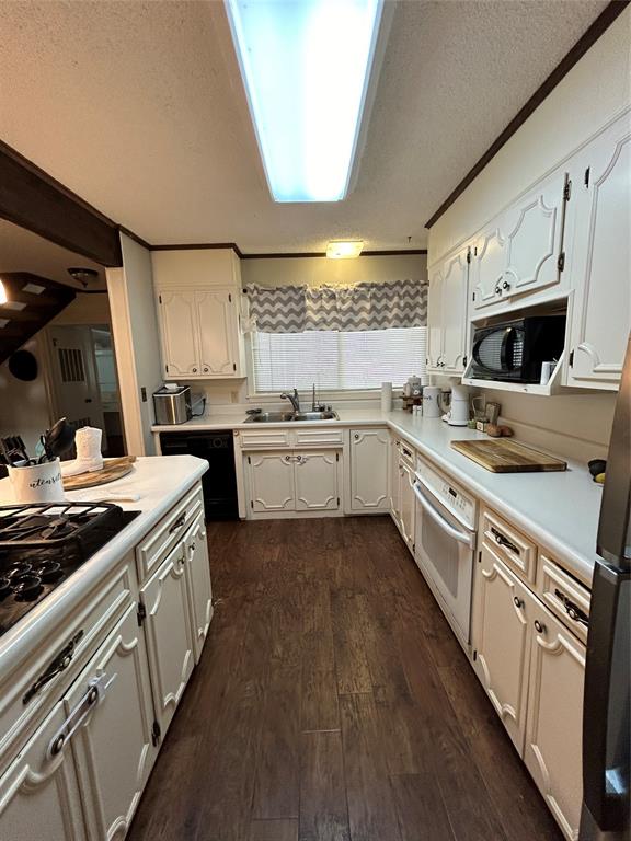 13 Rim Rock Road Goldthwaite, TX 76844 - Photo 10 of 30 a kitchen with stainless steel appliances a stove sink and cabinets