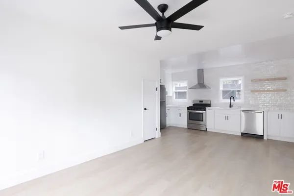 a kitchen with stainless steel appliances a refrigerator and cabinets
