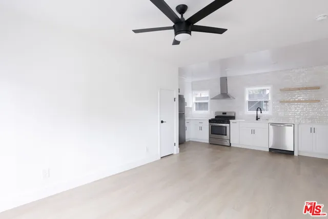a kitchen with stainless steel appliances a refrigerator and cabinets